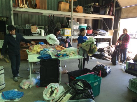 Creighton students organizing the storage unit. 2016.